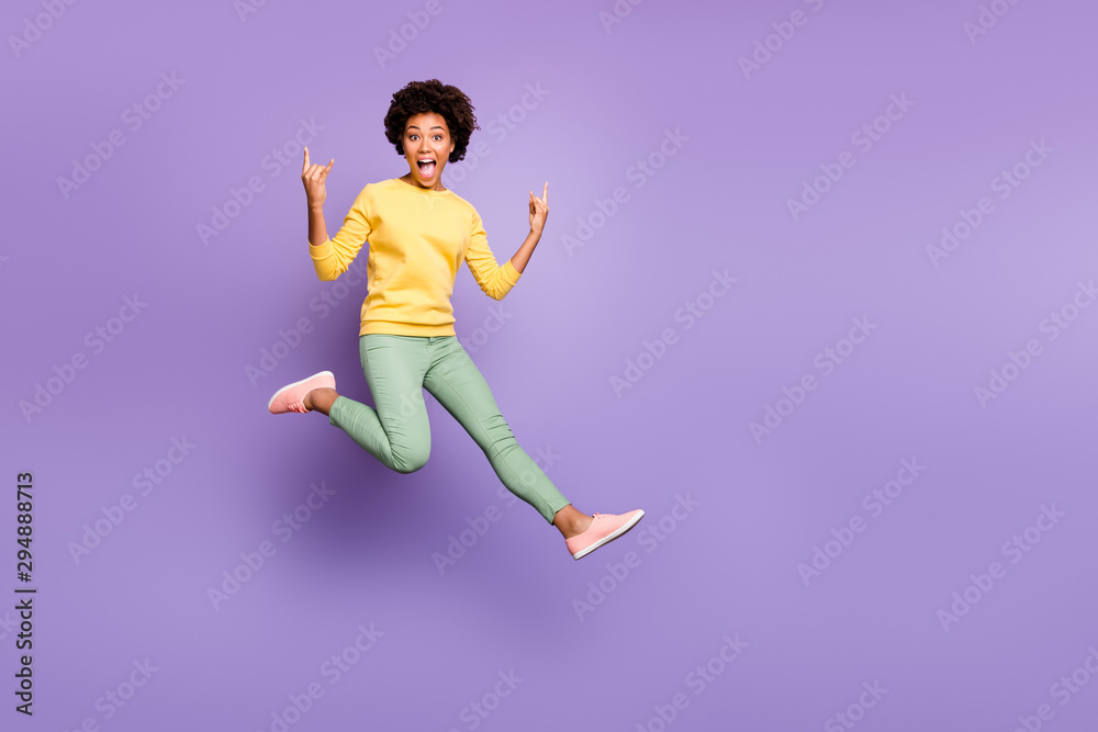 Lets rock. Full size photo of cheerful crazy girl fool on autumn spring holiday show horns true rocker sign wear yellow pullover green pants trousers isolated purple violet color background