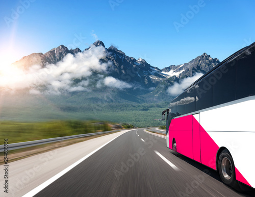 Unbranded tourist bus rushes along a beautiful highway. © Denis Rozhnovsky