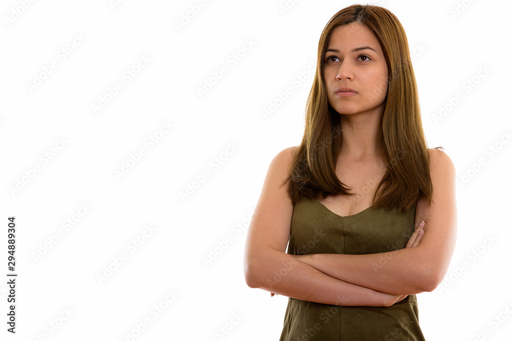 Studio shot of young beautiful woman thinking with arms crossed Studio shot of young beautiful woman thinking with arms crossed