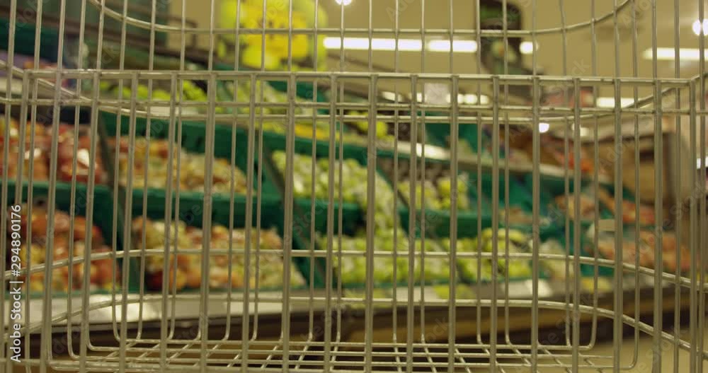 Empty Shopping Trolley Moving Through Aisles Of a SuperMarket. Passing By Other Shoppers Choosing What to Buy. British SuperMarket. Empty Shopping Trolley Moving Through Aisles Of a SuperMarket. Passing By Other Shoppers Choosing What to Buy. British SuperMarket.