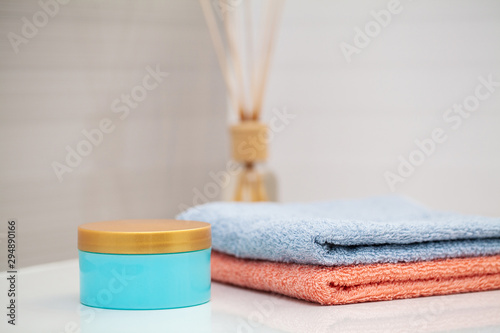 Color towels on white table with copy space on bath room background