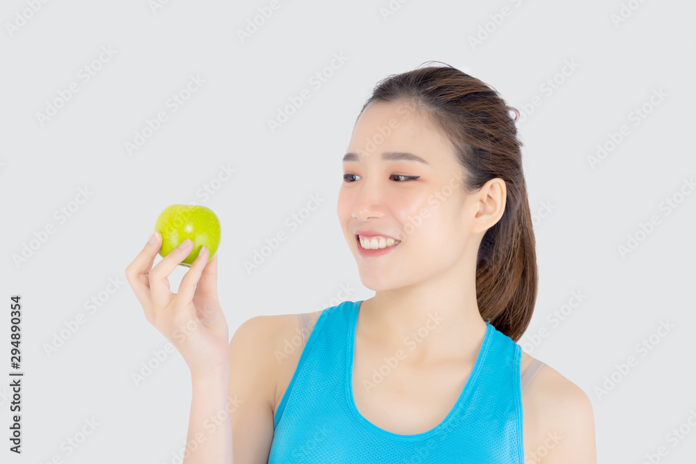 Beautiful portrait young asian woman in sport clothing with satisfied and holding green apple isolated on white background, girl asia have shape and wellness, exercise for fit with health concept. Beautiful portrait young asian woman in sport clothing with satisfied and holding green apple isolated on white background, girl asia have shape and wellness, exercise for fit with health concept.