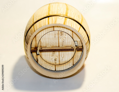 wooden barrel under honey or wine on a white background