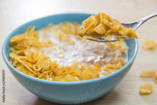 Photos A sky blue colored bowl of delicious corn flake cereals and milk and a spoon wit