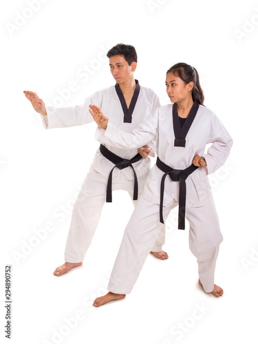 Male and female martial art practitioners perform strike move