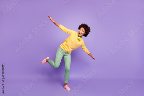 Fototapeta Naklejka Na Ścianę i Meble -  Full length body size view of her she nice attractive foolish cheerful cheery carefree dreamy wavy-haired girl having fun like plane flying isolated over violet purple lilac pastel color background