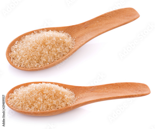 Brown sugar in wooden spoon on white background