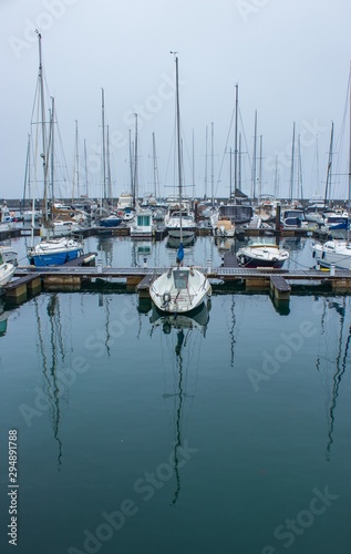 boats in marina with reflections in water © Artur Gomes