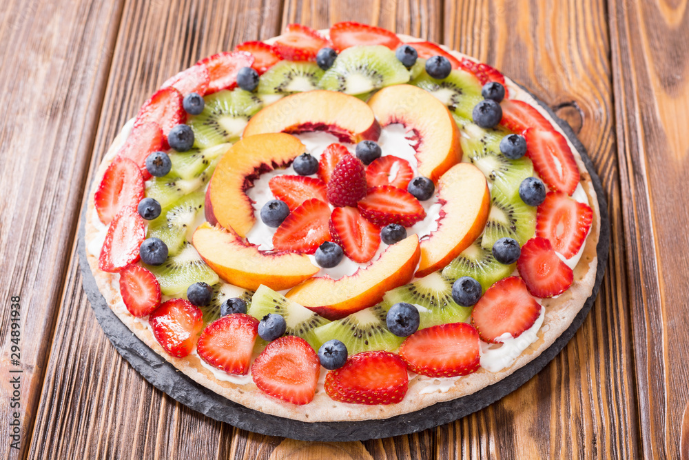Fruit pizza with fruit and berries .