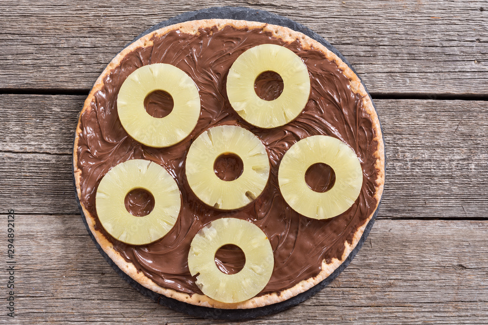 Fruit pizza with nut nougat cream and pineapple Fruit pizza with nut nougat cream and pineapple