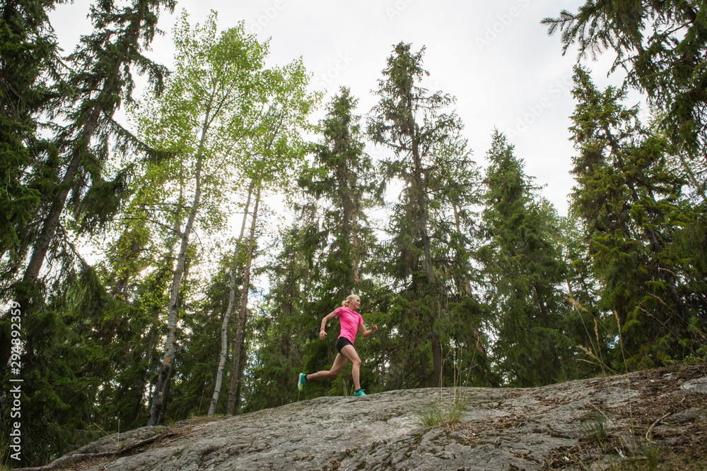 Woman running in forest Woman running in forest