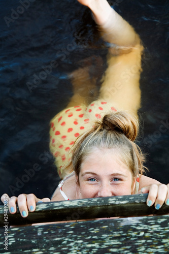 Teenage girl (16-17) swimming in sea photo