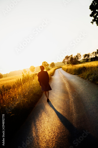 Woman walking on road on Gotland, Sweden photo