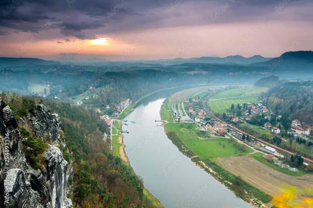 Fototapeta premium Elbsandstein mountains, view from panoramic Restaurant down River Elbe, Autuum with coloured trees, Germany