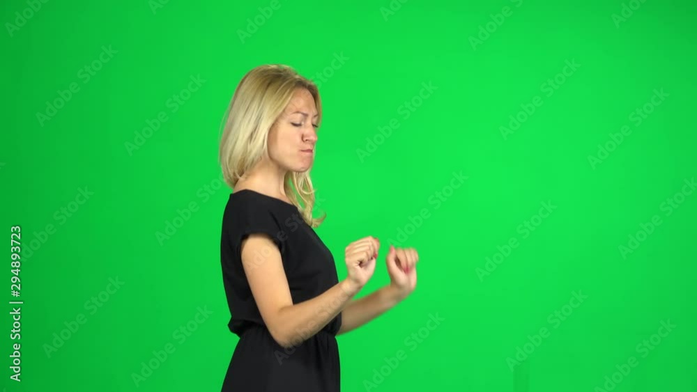 Cheerful girl walks and dancing , then shows thumbs up, sign like ok. Chroma Key. Side view Cheerful girl walks and dancing , then shows thumbs up, sign like ok. Chroma Key. Side view