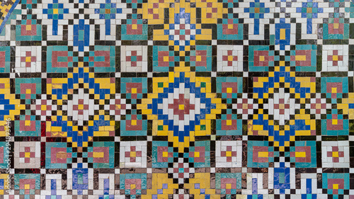 Colorful painting mosaic tiles on the wall at Golestan palace, Tehran, Iran © CanYalicn