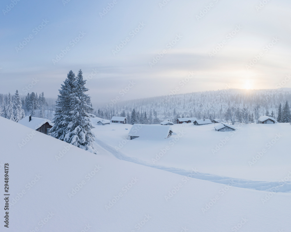 Log cabins covered in snow
