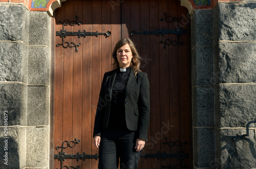 Portrait of priest outside church