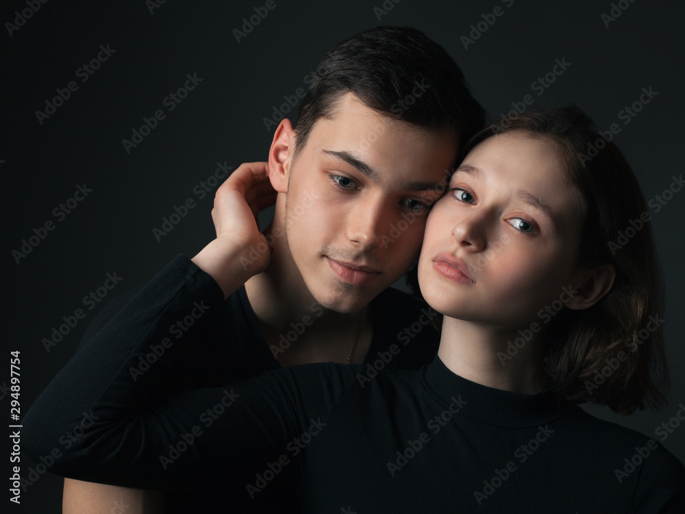 Young man and girl posing in studio. Young man and girl posing in studio.