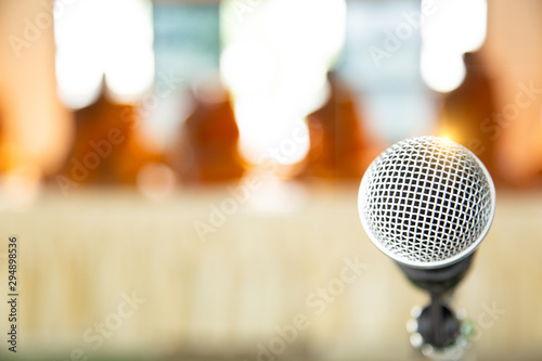 Microphone on abstract blurred of speech in seminar room or speaking conference hall. Meeting or Conference Training Learning Coaching Room Concept.