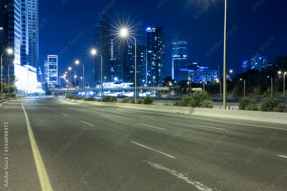 Fotografie Empty Freeway At Night And Tel Aviv Skyline in Background