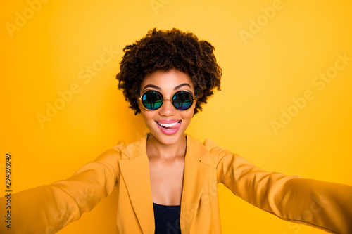 Close up photo of funny funky girl make selfie lick her lips have journey trip leisure time wear stylish fashionable suit isolated over yellow color background