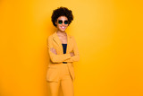 Portrait of her she nice-looking fashionable attractive pretty content cheerful cheery wavy-haired girl folded arms season trend isolated over bright vivid shine vibrant yellow color background