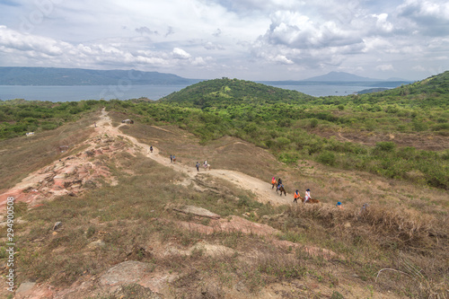 Tourists walking hiking trekking tour trail to Taal volcano, Batangas, Philippines photo