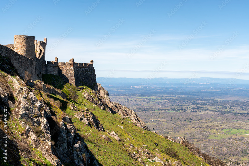 Marvao castle on the top of a mountain with beautiful green landscape behind on summer, in Portugal