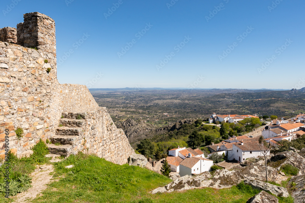 View of Marvao village with beautiful houses, church and wall with rocky landscape mountains behind