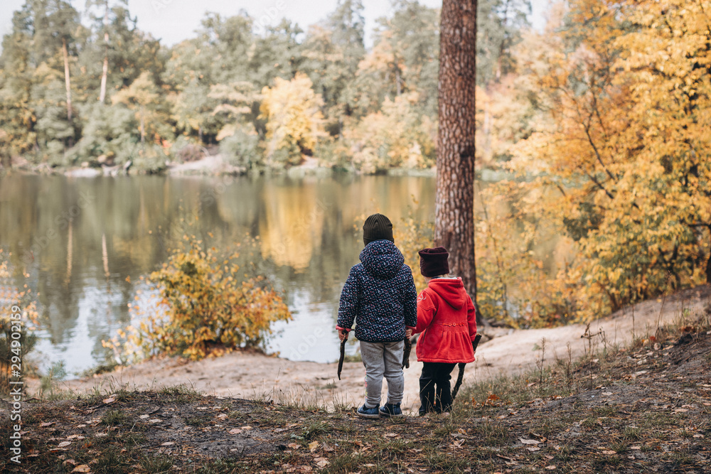 Fototapeta premium two kids walking in autumn forest