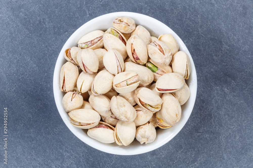 Pistachios pistachio nuts from above bowl slate Pistachios pistachio nuts from above bowl slate