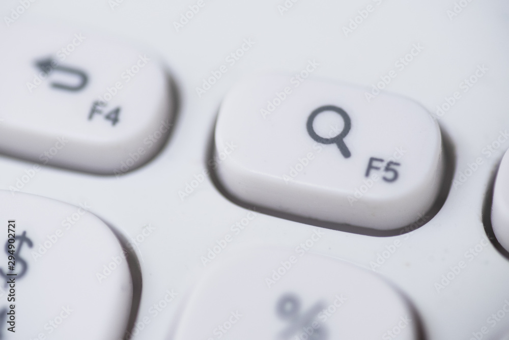Close-up of Search key, magnify glass icon of a white keyboard. Close-up of Search key, magnify glass icon of a white keyboard.
