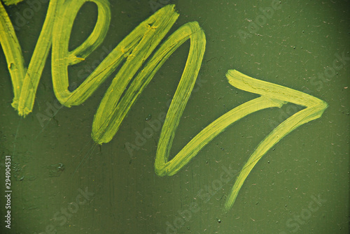 Bilde på lerret Yellow winding arrow on green background