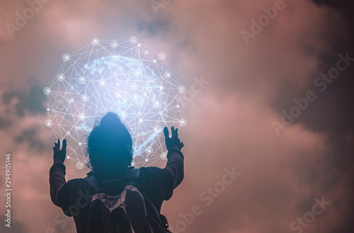  A man standing holding a globe with a background in the sky.Inspiration Concept