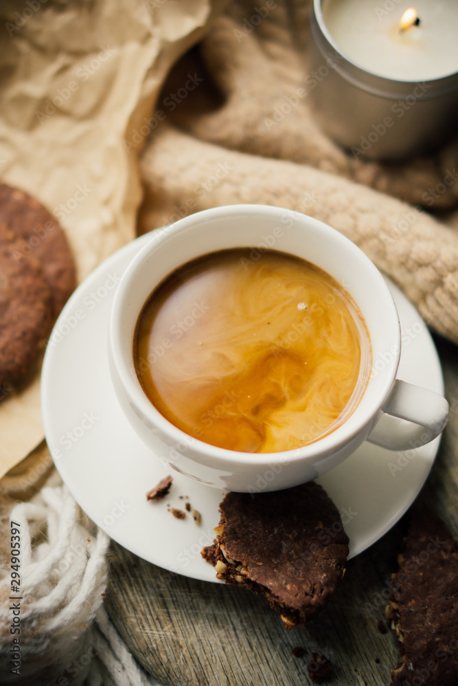 Cup of coffe with milk and chocolate cookies on warm wool blanket Cup of coffe with milk and chocolate cookies on warm wool blanket