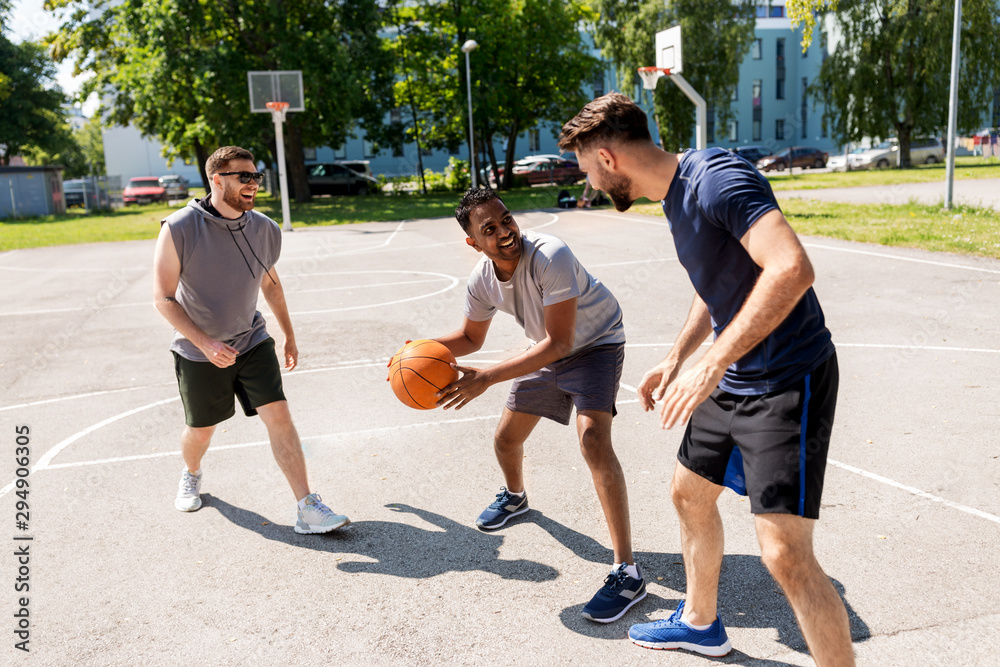 sport, leisure games and male friendship concept - group of men or friends playing street basketball