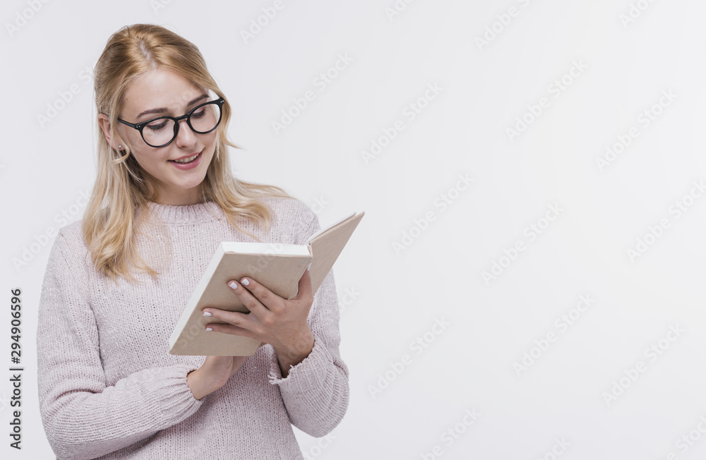 Pretty adult woman with glasses reading Pretty adult woman with glasses reading