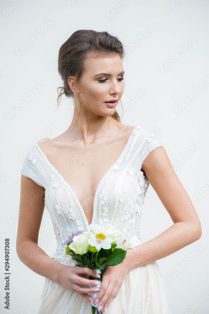 Beautiful bride with wedding flowers bouquet, attractive woman in wedding dress. Happy newlywed woman. Bride with wedding makeup and hairstyle. Smiling bride. Wedding day. Gorgeous bride. Marriage. Beautiful bride with wedding flowers bouquet, attractive woman in wedding dress. Happy newlywed woman. Bride with wedding makeup and hairstyle. Smiling bride. Wedding day. Gorgeous bride. Marriage.