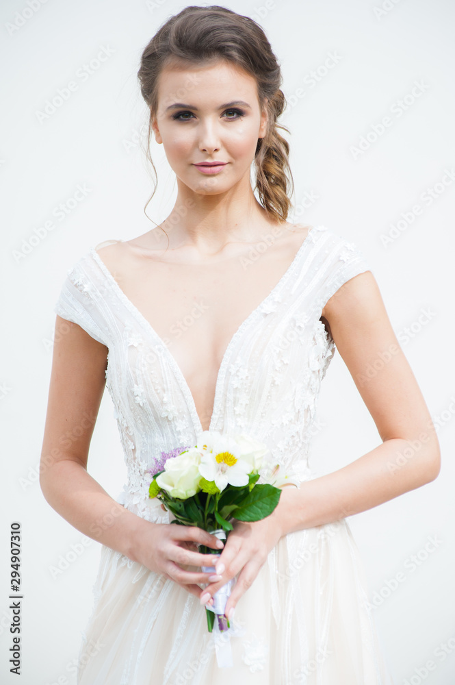 Beautiful bride with wedding flowers bouquet, attractive woman in wedding dress. Happy newlywed woman. Bride with wedding makeup and hairstyle. Smiling bride. Wedding day. Gorgeous bride. Marriage. Beautiful bride with wedding flowers bouquet, attractive woman in wedding dress. Happy newlywed woman. Bride with wedding makeup and hairstyle. Smiling bride. Wedding day. Gorgeous bride. Marriage.