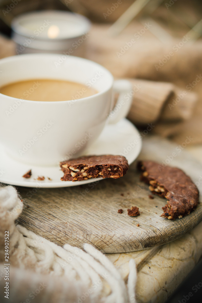 Cup of coffe with milk and chocolate cookies on warm wool blanket Cup of coffe with milk and chocolate cookies on warm wool blanket