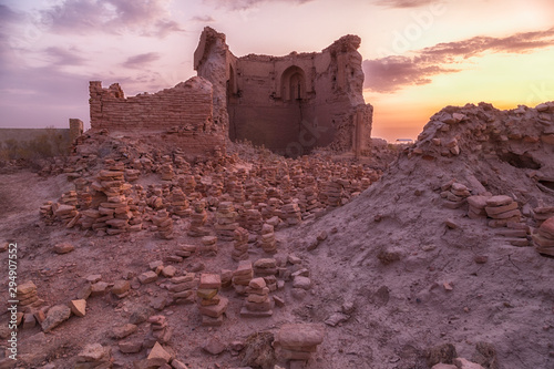 Ruins of medieval madrasah mosque of Caliph Rajab or World Clock on sunrise  . One of most ancient buildings in Central Asia . Located in necropolis Mizdakhan, Xojayli, near Nukus, Uzbekistan photo