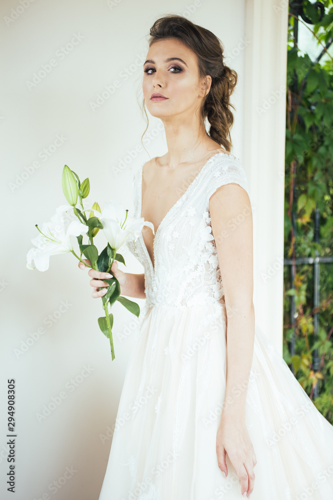 Beautiful bride with wedding flowers bouquet, attractive woman in wedding dress. Happy newlywed woman. Bride with wedding makeup and hairstyle. Smiling bride. Wedding day. Gorgeous bride. Marriage. Beautiful bride with wedding flowers bouquet, attractive woman in wedding dress. Happy newlywed woman. Bride with wedding makeup and hairstyle. Smiling bride. Wedding day. Gorgeous bride. Marriage.