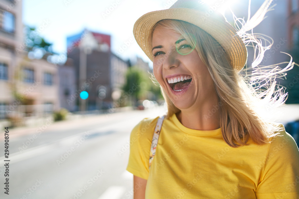 Portrait of laughing young woman in the city