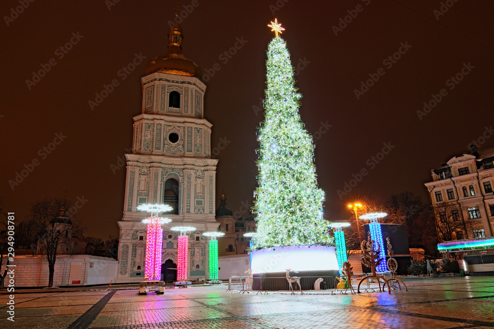 Scenic view of beautiful decorated main Kyiv's New Year tree. Sophia Square in Kyiv, Ukraine. The tower of Saint Sophia Cathedral on the background. Early winter morning, cityscape without people