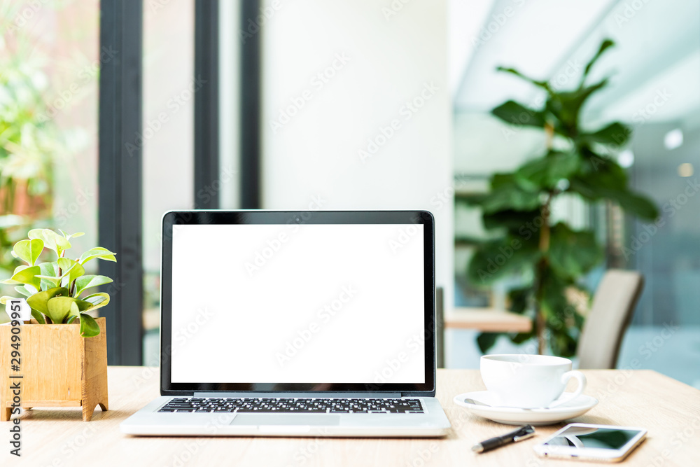 Mockup of laptop computer with empty screen with coffee cup on table of the coffee shop background,White screen