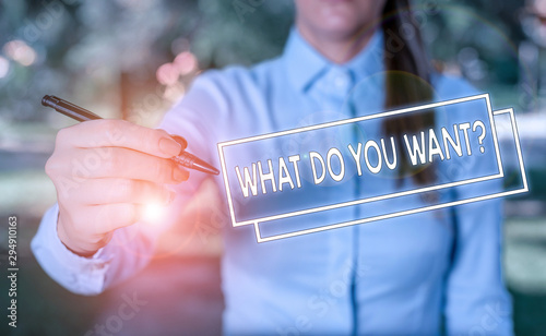 Word writing text What Do You Want Question. Business photo showcasing Tell me your desires requests deanalysisds ambition Woman in a blue business shirts pointing with her finger into empty space photo