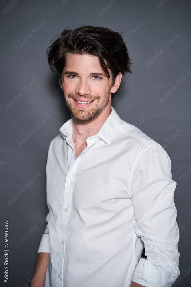 Portrait of smiling handsome man wearing white shirt Portrait of smiling handsome man wearing white shirt