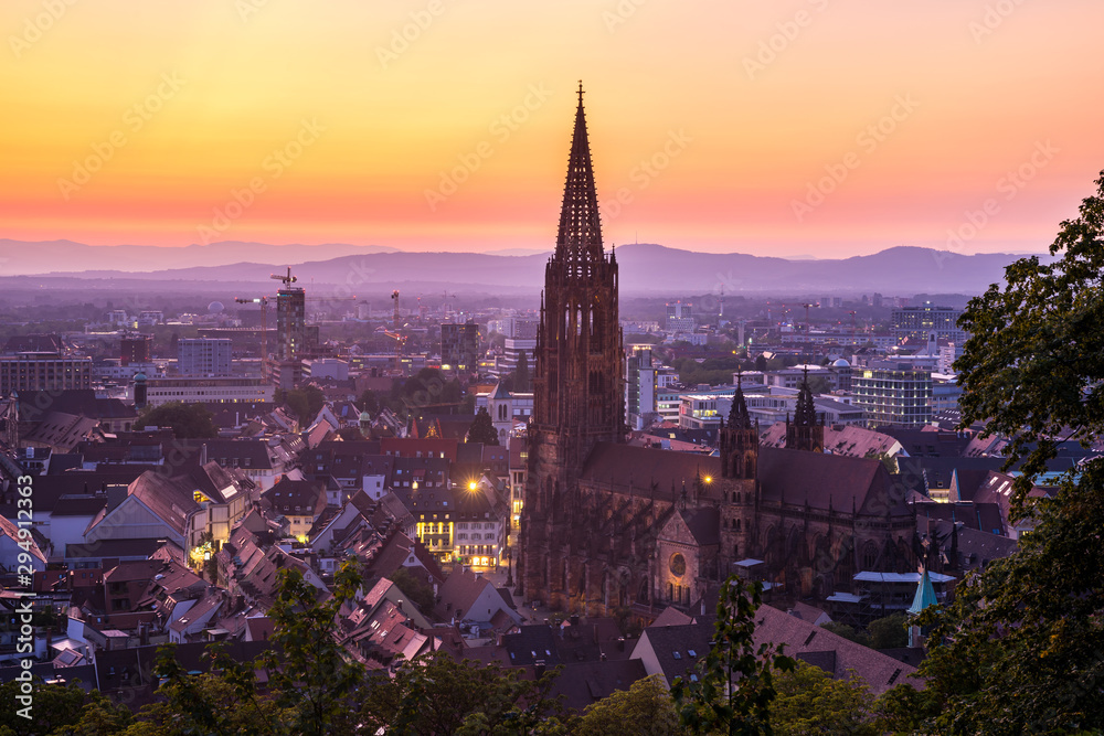 Germany, Amazing red sky sunset over medieval city freiburg im breisgau cathedral and skyline from above in summer