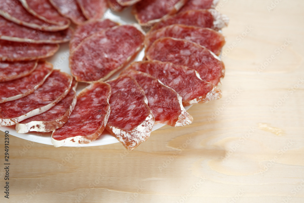 Slicing sausage on a plate